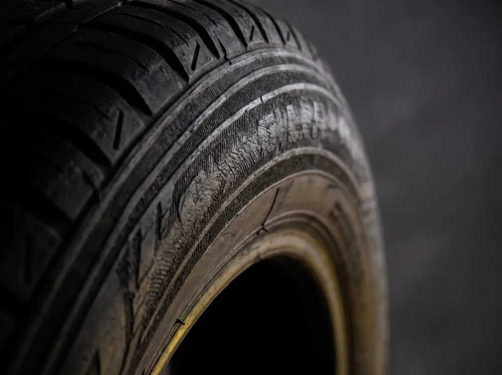 A close-up of a tyre's tread and sidewall